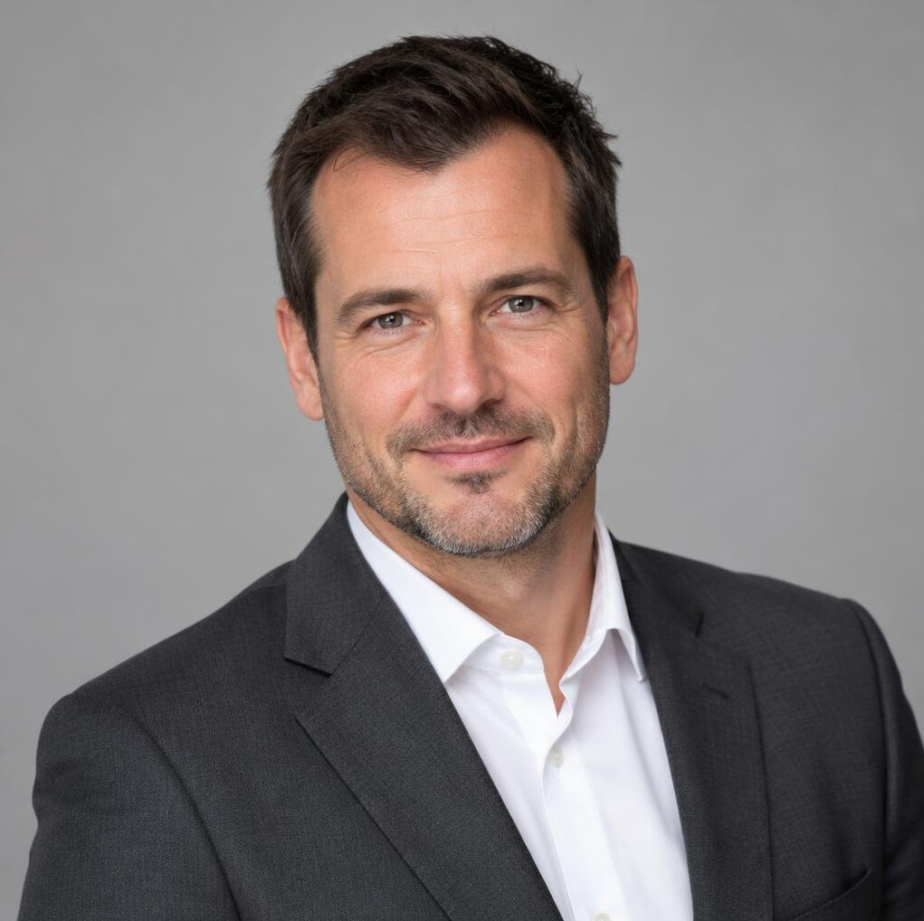 Portrait of a man in a suit with a confident smile